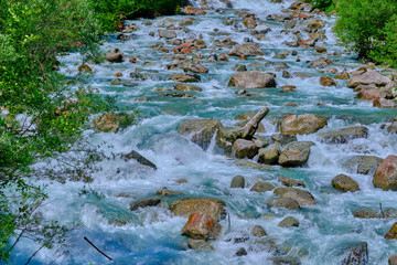 Mountain cold fresh water turquoise color of the Alpine mountains. Photo taken at long exposure.