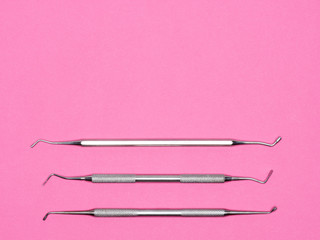 Dental tools on pink background with copy space. Dental care concept