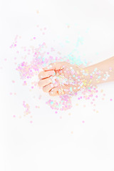 Pearl pastel confetti sparkles with woman hand