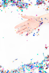 Woman hand with festive color star confetti