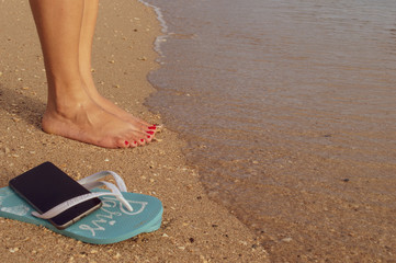 Fototapeta premium feet in sandals on beach