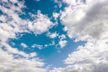 in the blue sky clouds and the sun.