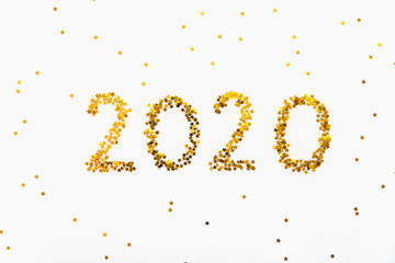 New 2020 Year golden star shaped confetti background.