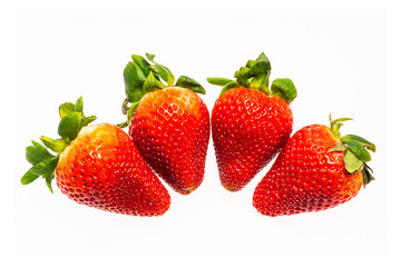 four strawberry isolated on white background.The fruit is not yet ripe.