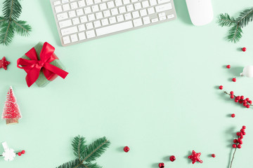 Christmas modern composition. keyboard, gift, fir branches, red berries, Xmas decorations on mint background. Christmas, New Year, winter concept. Flat lay, top view, copy space