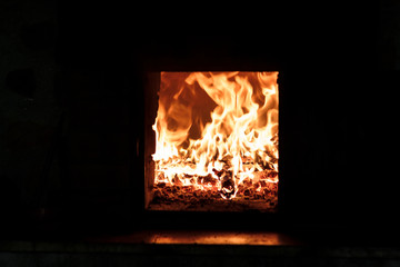 Burning wood oven at night
