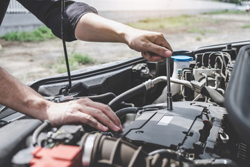 Services car engine machine concept, Automobile mechanic repairman hands repairing a car engine automotive workshop with a wrench, car service and maintenance