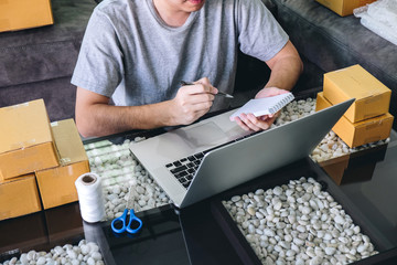 Small business parcel for shipment to client at home, Young entrepreneur SME freelance man working...