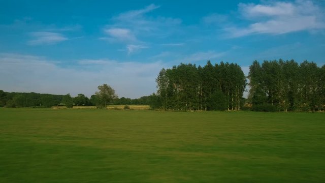 Passenger view of amazing croplands and rolling hills in the Cotswolds in England, UK, an Area of Outstanding Natural Beauty with 787 square miles, the second largest protected landscape in England