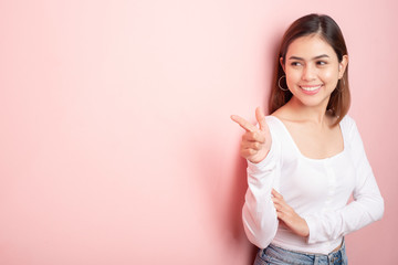 Beautiful university student is smiling on pink background