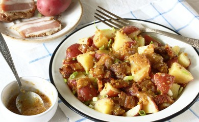 German potato salad with fried bacon and mustard dressing. traditional for oktoberfest festival.