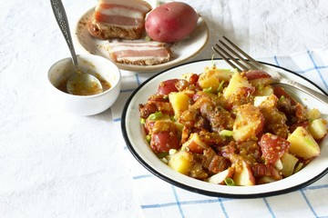 German potato salad with fried bacon and mustard dressing. traditional for oktoberfest festival.