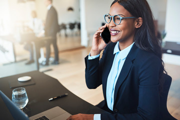 African American businesswoman talking on a cellphone in an offi