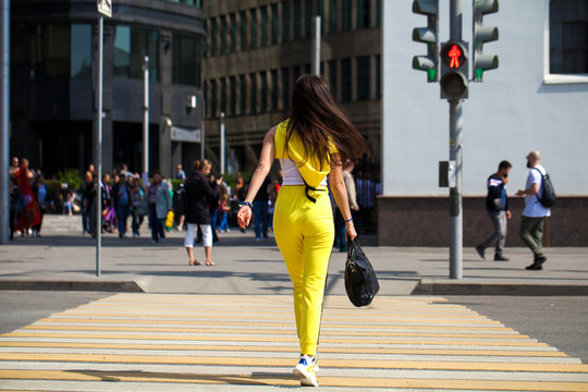 Portrait Of A Young Beautiful Brunette Woman In Yellow Tracksuit