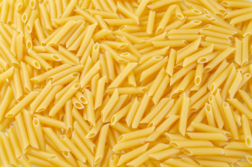 Dry Penne Rigate pasta background.