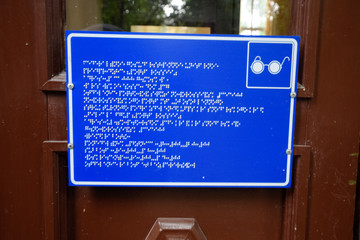 Obraz premium plate with a tongue for the blind on the doors of the building.