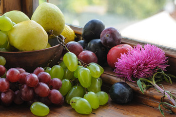 ripe fruits and flowers on the wooden table