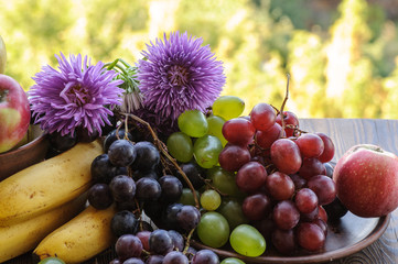 ripe fruits and flowers on the wooden table