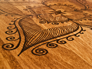 Detail of wood burning. Abstract native american patterns.