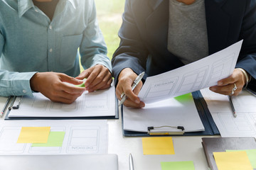 UX or UI designers designing on their smartphone application layout prototype project.