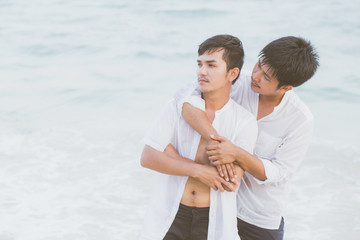 Homosexual portrait young asian couple standing problem on beach in summer, asia gay angry and unhappy in vacation at sea, relationship with disappointed and frustrated, LGBT with legal concept.