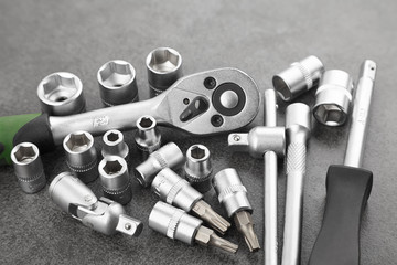 ratchet set with heads, different socket wrenches close-up on a dark stone background