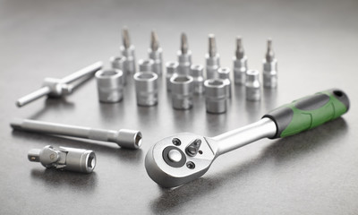 ratchet set with heads, different socket wrenches close-up on a dark stone background