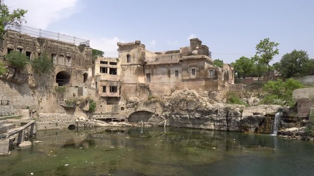 Chakwal Qila Katas Raj Hindu Temples Dedicated to Shiva Surround a Pond with Waterfall on a Sunny Blue Sky Day