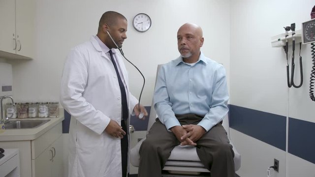 Doctor checks patient lung, breath in doctor office, hospital exam room, wide