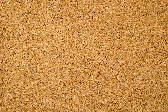 Close-up of brown cork board texture background. Empty bulletin board, natural texture detail with free space copy for text.