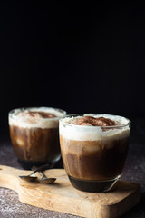 Affogato coffee with ice cream on a glass cup, dark, black background.
