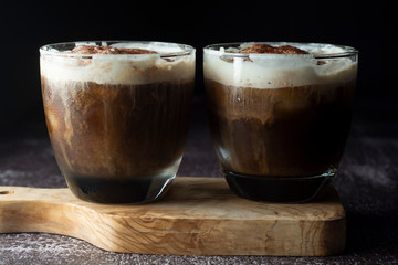 Affogato coffee with ice cream on a glass cup, dark, black background.