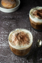 Affogato coffee with ice cream on a glass cup, dark, black background.