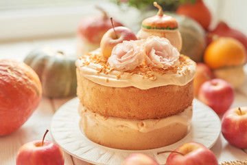 Naked Cake with Apples. Thanksgiving Day table. Happy Halloween Pumpkins, apples and flowers. Bright autumn background. Colorful autumn card. Autumn flower arrangement. Autumn bouquet