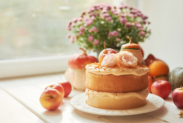 Naked Cake with Apples. Thanksgiving Day table. Happy Halloween Pumpkins, apples and flowers. Bright autumn background. Colorful autumn card. Autumn flower arrangement. Autumn bouquet