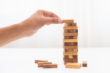 hand holding a wooden block