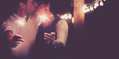 New year and romance couple of caucasian people man and woman kissing celebaring the nightlife...