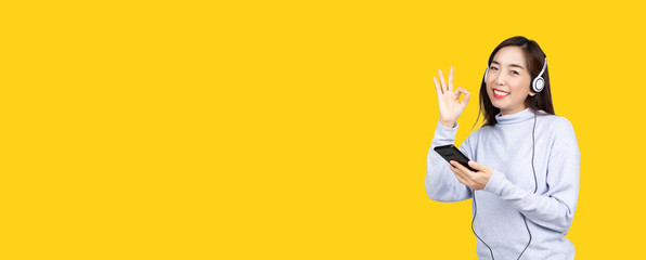 Asian women do activities put on headphones listen to music And choose to shop products online such...