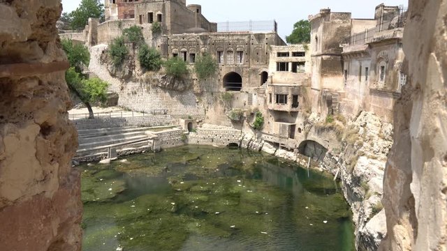 Chakwal Qila Katas Raj Hindu Temples Dedicated to Shiva Surround a Pond with Waterfall on a Sunny Blue Sky Day