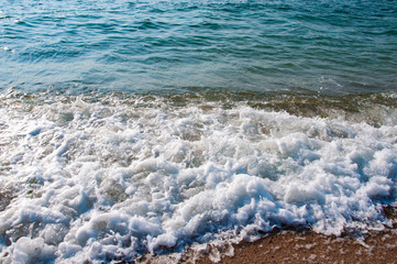 .Sea shore waves sand stones beautiful.