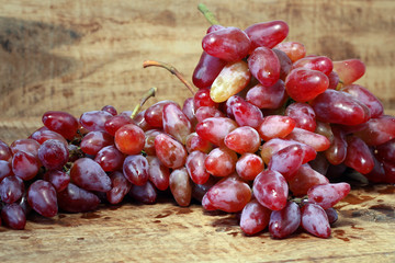 bunch of red grapes on wooden background