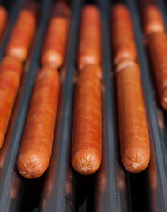 Close up of hot dog sausages on grill