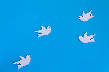 white gecorative dove of peace and love symbol flying on light blue background
