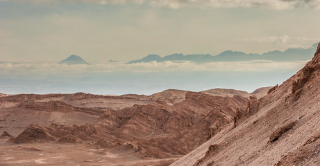 Sand formations, mountains, rocks at Valle de la Luna Moon Valley, San Pedro de Atacama Chile. Wide view of stunning sun rise on sand formation in world famous Atacama desert Chile. Salt formations
