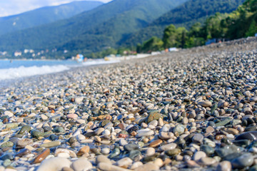 rest on the sea, pebble beach and waves, near the mountains