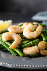 Salad from shrimp and green asparagus. Healthy seafood salad in plate. Top view.