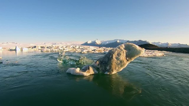 Aerial view of glacier lagoon Jökulsárlón in Iceland with green water, floating ice and glacier