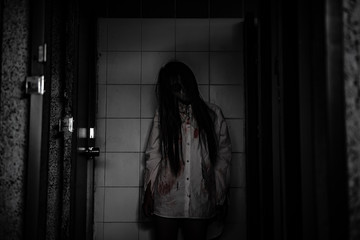 Portrait of asian woman make up ghost face with blood,Horror scene,Scary background,Halloween...
