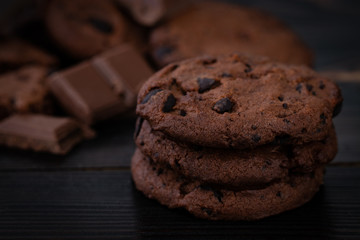 Chocolate cookies on wooden table. Homemade food on wooden background