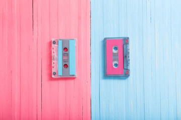 Old plastic cassette on wooden background. Retro music concept